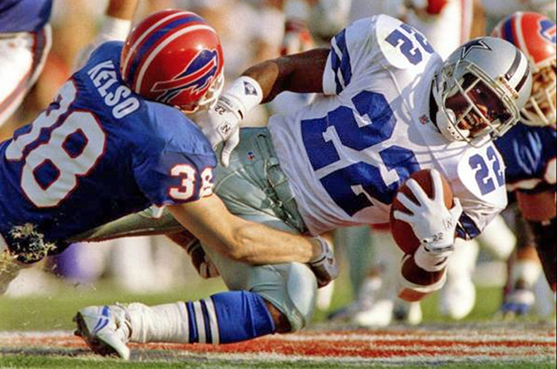 Football player Mark Kelso of the Buffalo Bills tackles a player on the opposing team